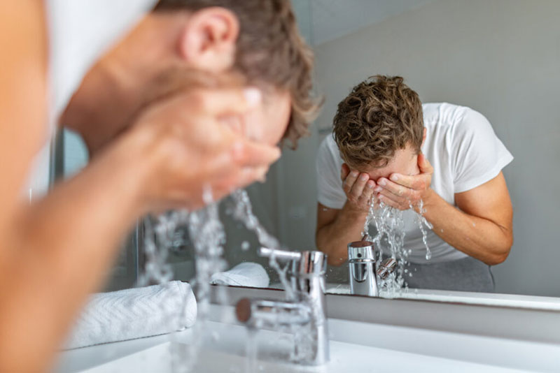 man-washing-face